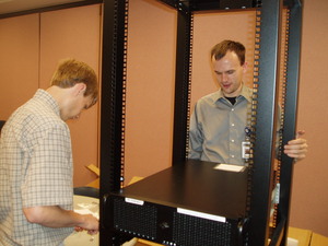 Daniel and Robert building racks and servers at the health department.