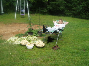 Soon corn season started and we spent two days freezing 24 quarts of cut corn! Here Daniel is taking a needed break after shucking a large pile of corn.