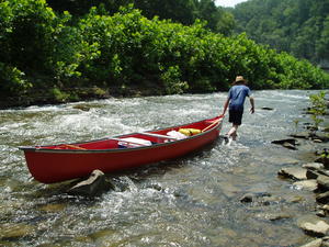 We got to a section of rapids, so we parked one canoe, and Daniel dragged the other canoe through the water, while the rest of us walked behind him. All four of us piled into one canoe and continued on down the river.