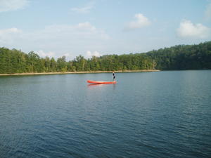 Daniel trying to see how far back on the tip of the canoe he can balance without landing in the water.