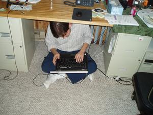 David hiding under Daniel's desk while doing his mischevious work.