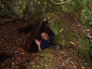 One tree (growing on top of the rock) fell over partway, but some of its roots were able to keep it on. The moss covering its roots created a cave, so Erick climbed in!