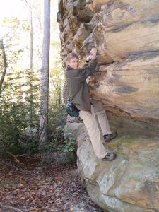 Daniel climbing around on the rock wall on the outside.
