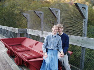 Daniel and Kristina sitting in an old coal car on the bridge.