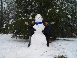 This is Robert and Daniel with our 7-foot snowman! We had a blast making it, but had to build a snow ramp to haul the second ball onto the first one! It was HEAVY!