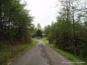 Here's the driveway--our mailbox is that little dot at the bottom of the hill, and you can see our house hiding in the trees just beyond it. We are blessed with asphalt and county road right to our mailbox! God is good. :)