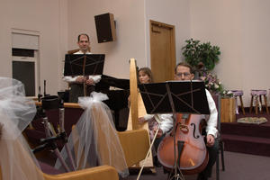 Musicians Ed, Lisa, and Harvey ready for their cue.