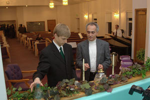 Daniel and Pastor Sam discussing the candle lighting.