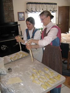 Elisabeth and Kristina rolling dough into long strands for the boulkas rolls.