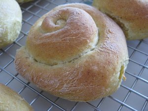 Close-up photo of a boulkas roll. It is made out of the challah dough.