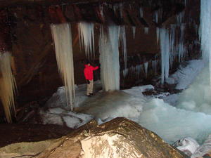 Daniel checking out another massive set of icicles behind the falls.