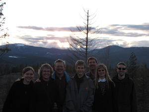 The hikers enjoying the sunset before trudging back through the woods.