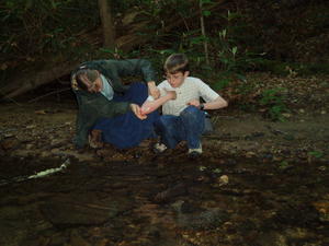 Kristina washing off Levi's scraped up arm, after he tripped and fell.