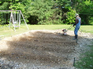 Levi tilling a second garden plot for the summer vegetables--green beans, squash and cucumbers.