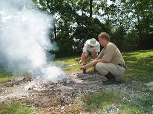 Dad and Andrew roasting veggie dogs