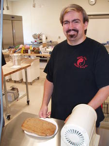 Anton having fun making his own pizza.