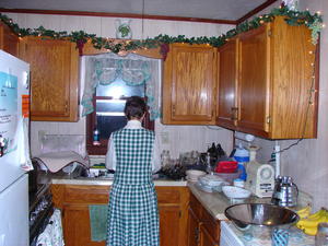 Mom helping with the dishes after supper.