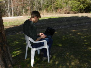 Daniel programming outside to enjoy the fresh air.
