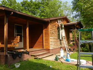 Front porch and swing finished, now for the front face. Daniel's on the ladder.