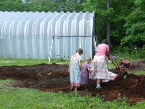 Our garden FINALLY dried out! So Tammie brought her tiller over and helped us get all the aged sawdust tilled into the hard clay. Her girls played follow-the-leader behind her.