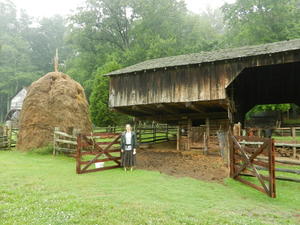 Danielle in front of the old barn and the haystack.