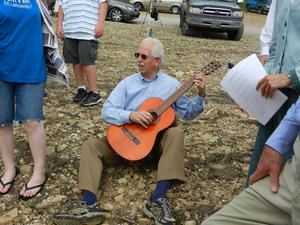 Jim helping to lead the singing with his guitar.