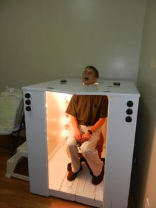 Daniel trying out the light therapy cupboard.