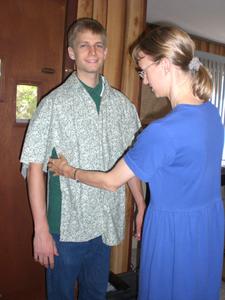 Kristina's next sewing project was a shirt for Daniel. Here she's trying to see what size he needs.