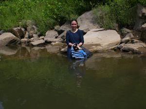 Kim relaxing on a rock.