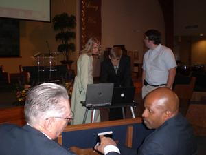 Daniel and Kristina were speakers at an Evangelism Summitt in Lexington. Here, two of the other speakers, Olin and Ralph are discussing technical issues while Daniel and Kristina get the computer working.