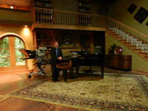 Mark at the piano where they film music.