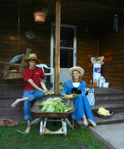 Daniel and Kristina shucking corn for freezing.