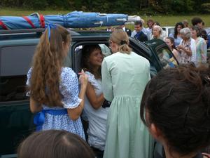 Kristina finishing her last responsibilities before the bride and groom drive away.