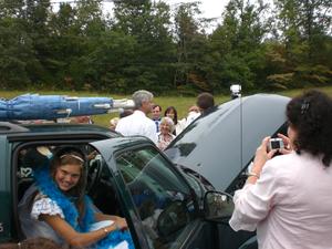 Well..... they were going to drive away, but the car started honking when they started it up! Groom is hunting for the source of noise under the car hood.
