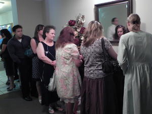 Kristina assisting at the guest book until the guest book attendant arrives.