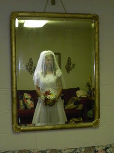 The bride making her last check in the mirror and taking her last deep breaths before the wedding begins.