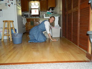 Kristina mopping the floor after making nearly 60 quarts of applesauce with Rita and Daniel.