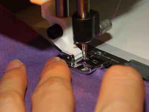 putting the last stitches in the hem.