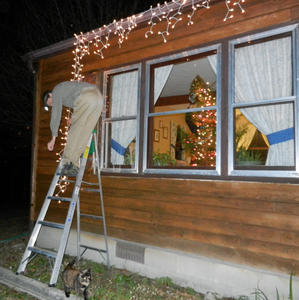 While Daniel put the lights up outside the window.