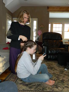 Kristina braiding Madeleine's hair.