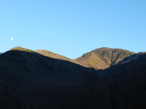 The full moon with the glow over the mountain.