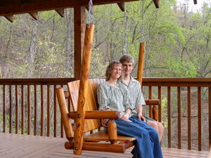 The porch swing on the porch, facing the view.