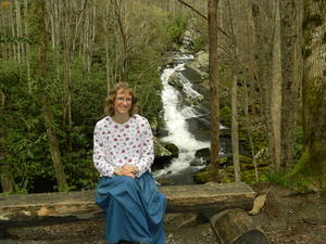 Kristina enjoying a rest on the bench, with the cascades behind her.