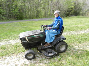 Kristina mowing the lawn--we had a cold front come through so she had to bundle up to stay warm on the mower!