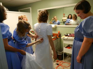 Kristina helping Kristina B (almost A!) get her wedding dress on!