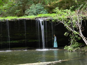 Kristina walking under the falls.