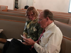 Kristina going over the program with the Bride's Father, Pastor Fred.