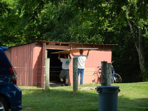 Daniel and his Dad hauling drywall sheets at their house.