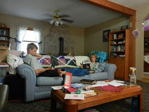 Daniel and Kristina taking some time to rest and read on the couch.