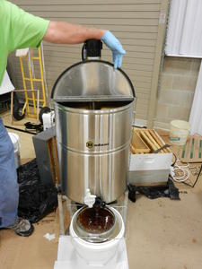 One of our local bee keepers doing a demonstration on how he extracts his raw honey.